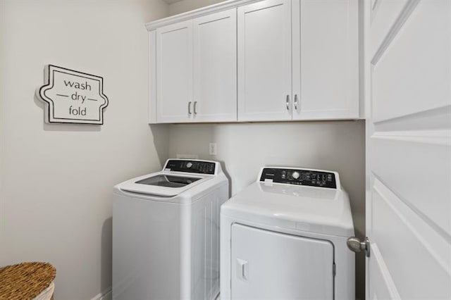 washroom with washer and dryer and cabinet space