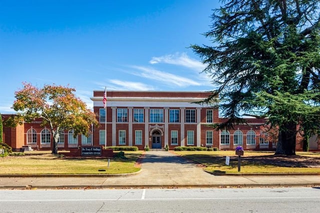 neoclassical home with a front lawn