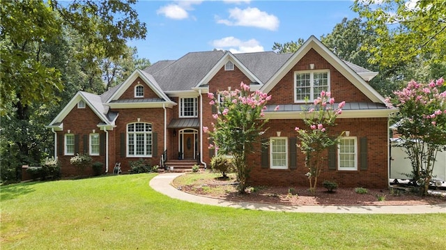 view of front of house featuring brick siding and a front lawn