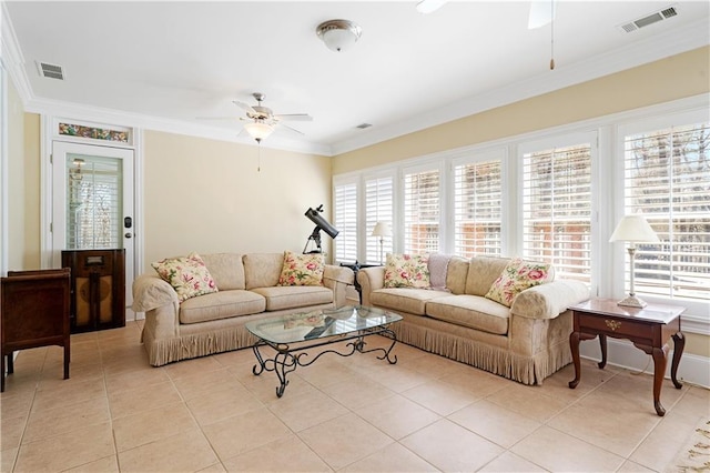 living area featuring light tile patterned floors, a ceiling fan, visible vents, and ornamental molding