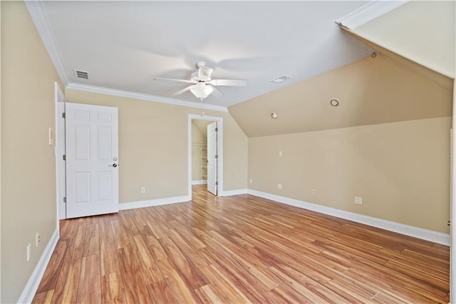 additional living space featuring visible vents, baseboards, vaulted ceiling, and light wood finished floors