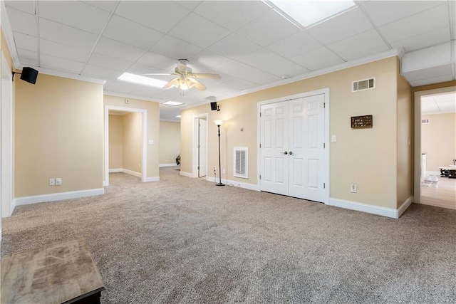 interior space featuring visible vents, baseboards, and carpet flooring