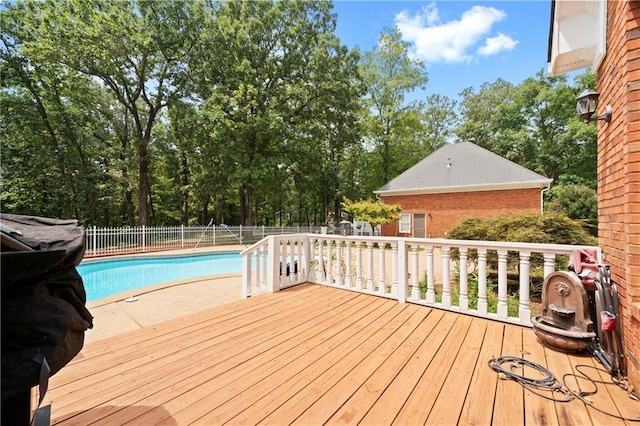 wooden deck featuring a fenced in pool and a fenced backyard