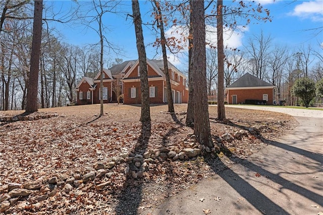 colonial-style house with brick siding and driveway