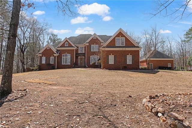 colonial house featuring brick siding