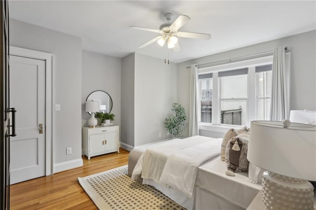 bedroom with ceiling fan and light hardwood / wood-style floors