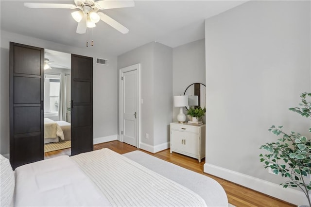 bedroom with ceiling fan and light hardwood / wood-style flooring