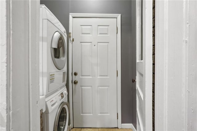 laundry room featuring stacked washer and clothes dryer