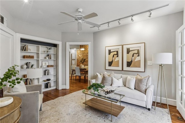 living room with wood-type flooring and ceiling fan