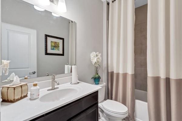 full bathroom with shower / bathtub combination with curtain, vanity, and toilet