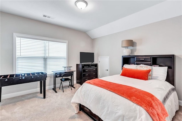 carpeted bedroom featuring vaulted ceiling