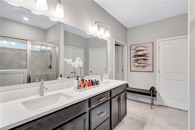 bathroom with tile patterned floors, vanity, and a shower with door