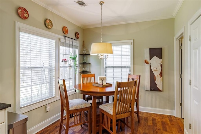 dining space featuring dark wood finished floors, a healthy amount of sunlight, visible vents, and ornamental molding