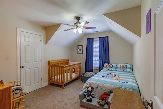 carpeted bedroom featuring vaulted ceiling, visible vents, and ceiling fan