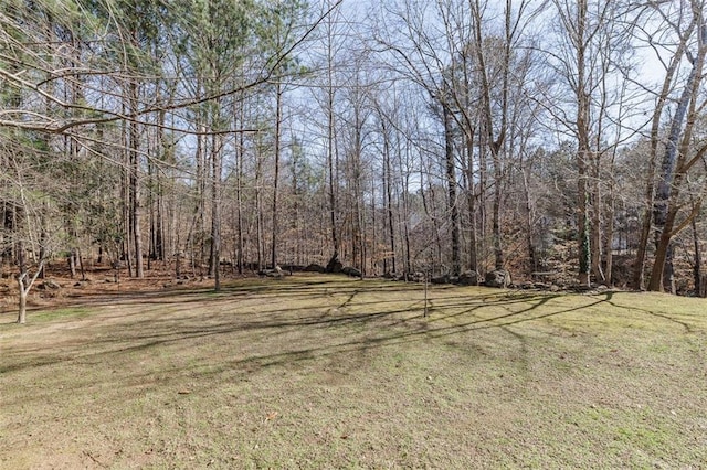 view of yard with a view of trees