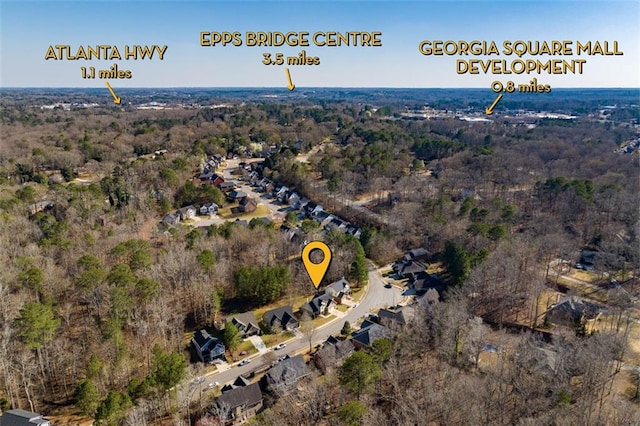 birds eye view of property featuring a view of trees