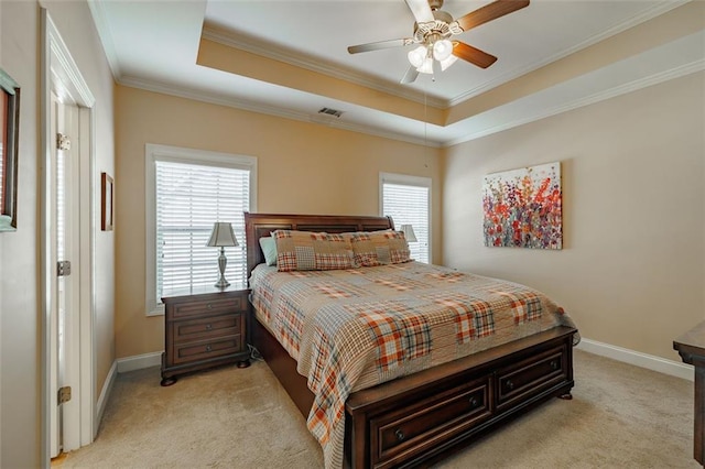 bedroom with a raised ceiling, crown molding, baseboards, and light carpet