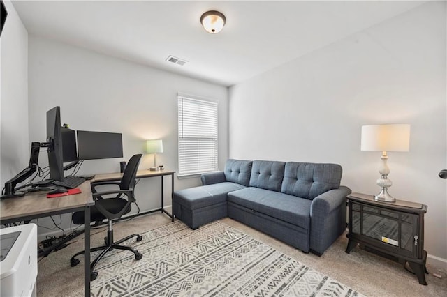 carpeted home office with visible vents and baseboards