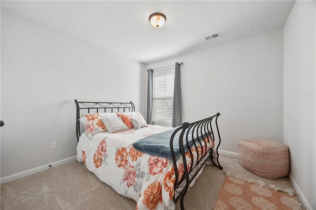 bedroom with carpet floors, visible vents, and baseboards