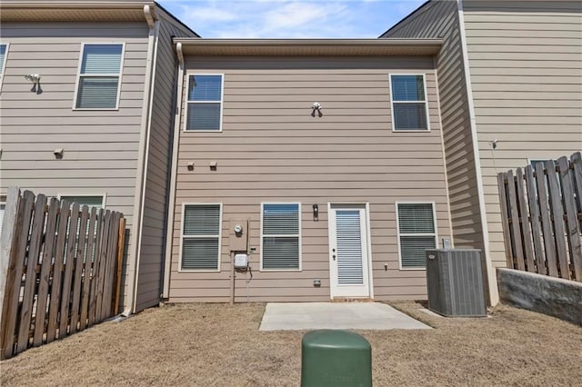 back of house featuring a patio area, fence, and central air condition unit