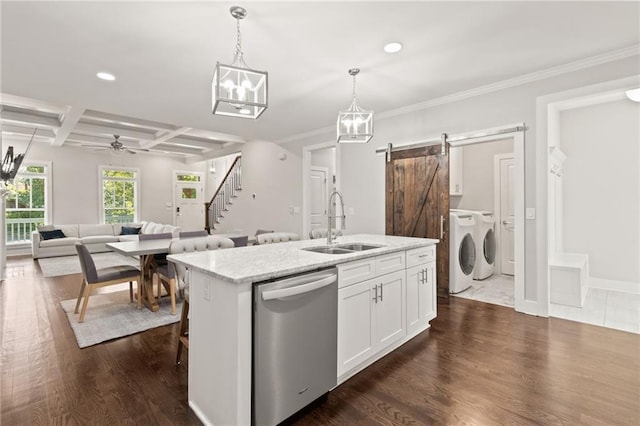 kitchen featuring a barn door, coffered ceiling, dishwasher, washer and dryer, and a sink