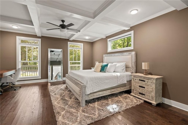 bedroom featuring baseboards, dark wood-type flooring, and beam ceiling