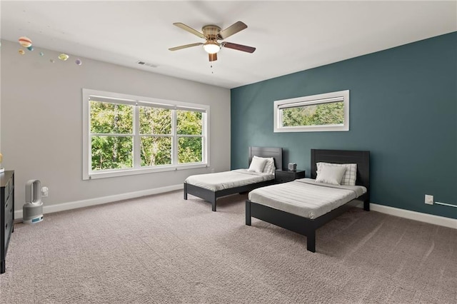 bedroom with carpet, visible vents, baseboards, and a ceiling fan