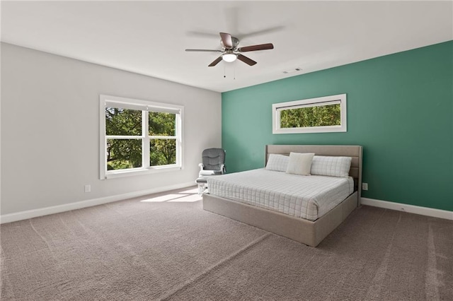carpeted bedroom with baseboards, visible vents, and a ceiling fan