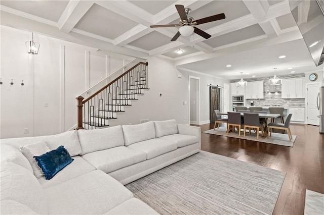 living area with wood finished floors, beam ceiling, recessed lighting, a ceiling fan, and coffered ceiling