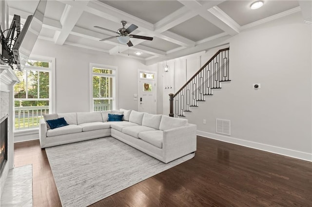 living room featuring stairs, visible vents, ceiling fan, baseboards, and a fireplace with flush hearth
