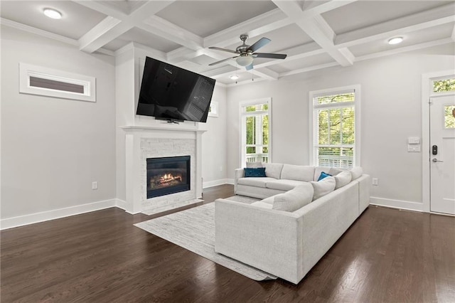 living room with baseboards, a stone fireplace, dark wood finished floors, and beam ceiling