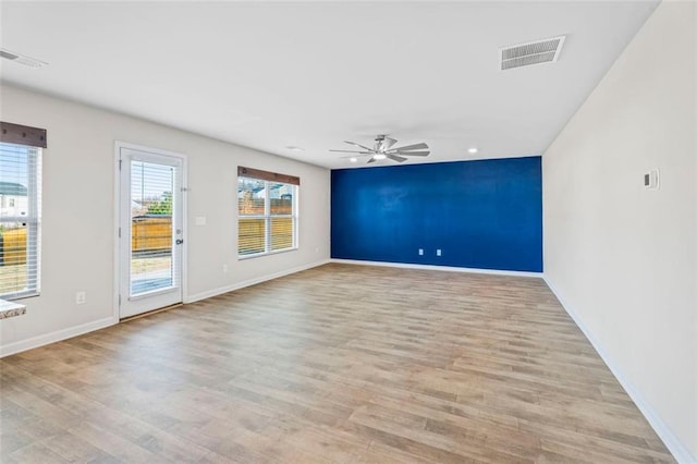 unfurnished room featuring ceiling fan and light hardwood / wood-style flooring