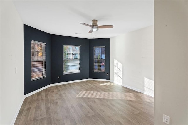 empty room with ceiling fan and light wood-type flooring