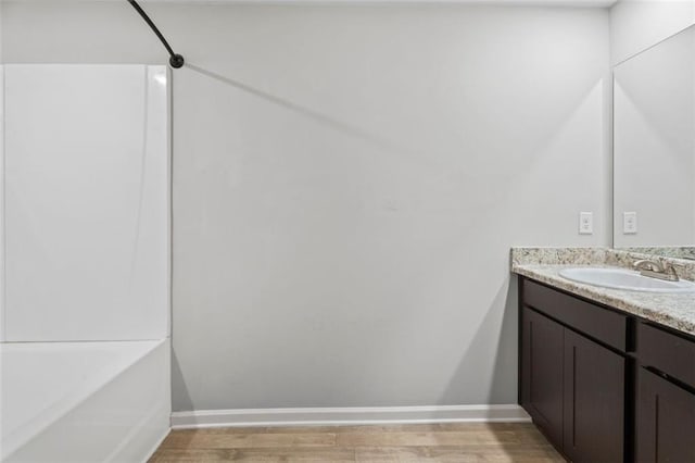 bathroom featuring shower / bath combination, vanity, and wood-type flooring