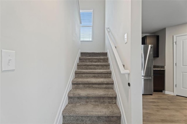 stairway with hardwood / wood-style floors