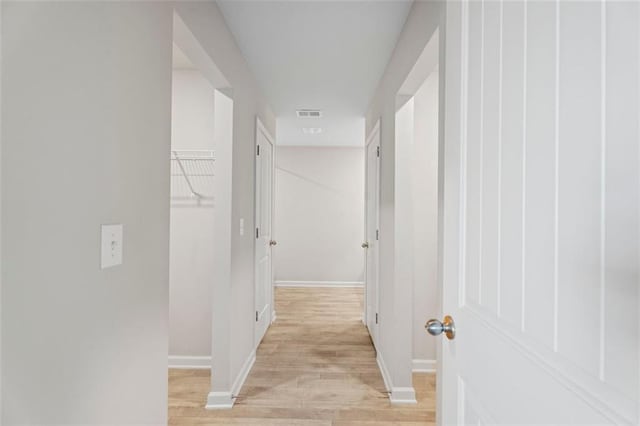 corridor with light hardwood / wood-style flooring