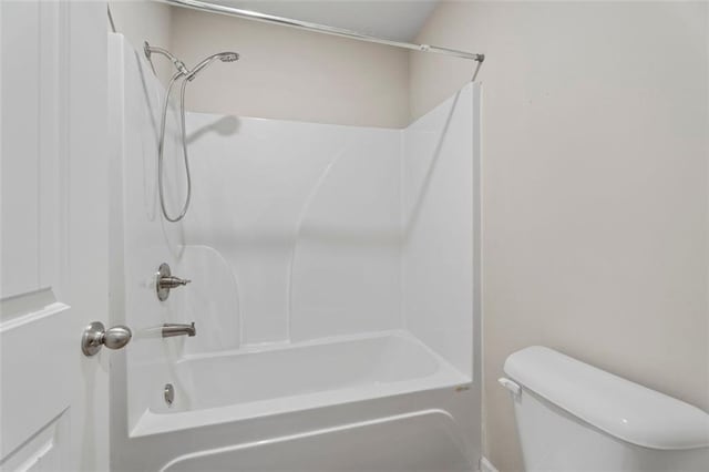 bathroom with toilet and bathtub / shower combination