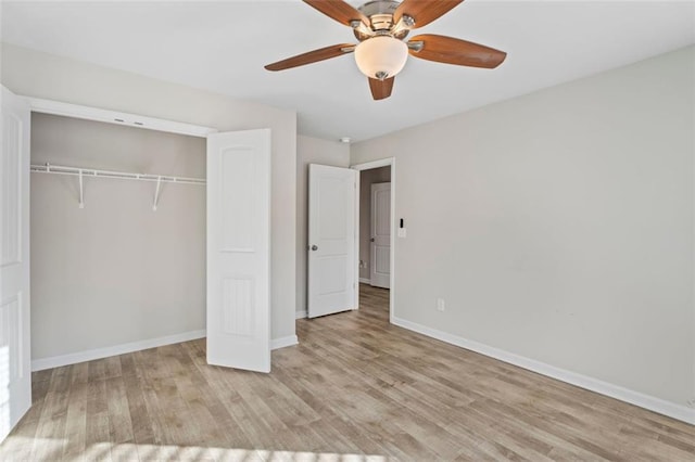 unfurnished bedroom featuring a closet, light hardwood / wood-style floors, and ceiling fan