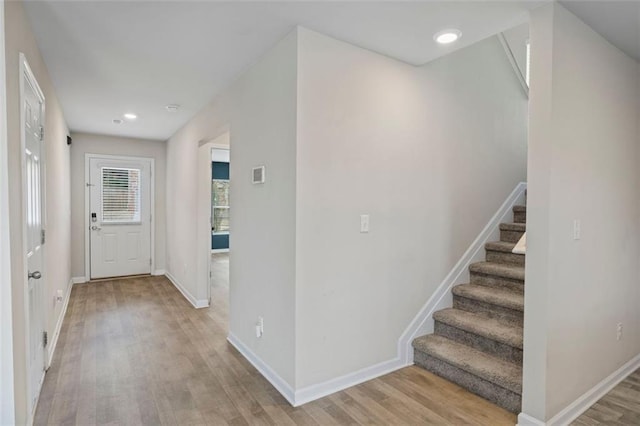 foyer entrance with light hardwood / wood-style floors