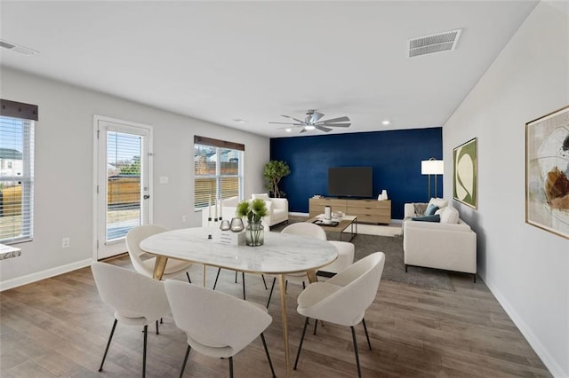 dining space featuring hardwood / wood-style floors and ceiling fan