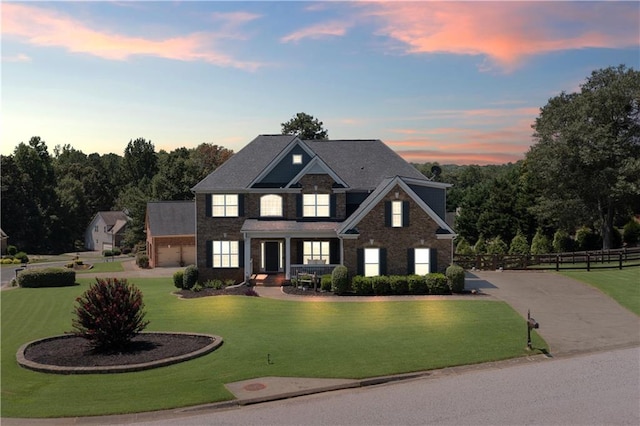 view of front facade with a garage and a yard