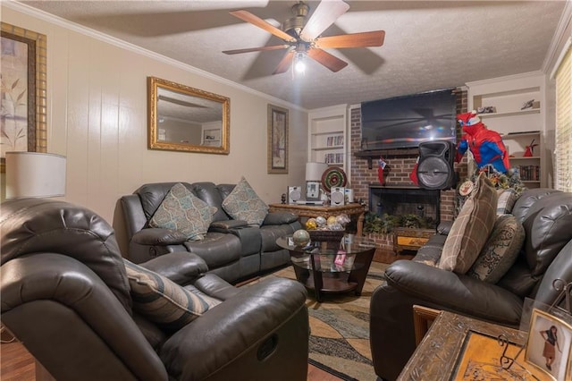 265 Forest Lake Dr, Covington, GA 30016 - living area featuring wood finished floors, built in shelves, ceiling fan, a fireplace, and a textured ceiling