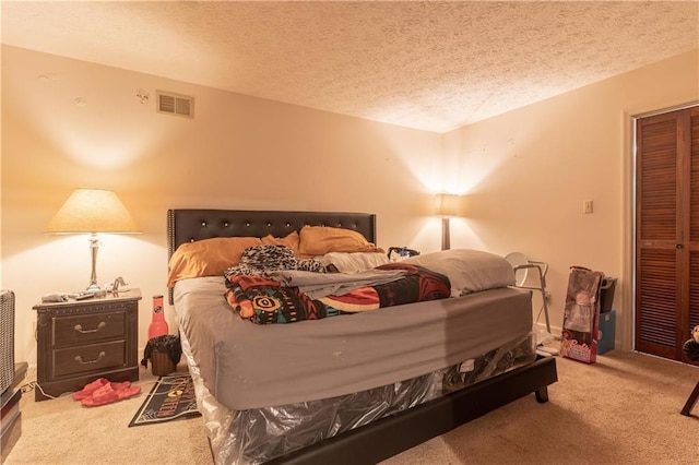 265 Forest Lake Dr, Covington, GA 30016 - bedroom with carpet, a textured ceiling, and a closet