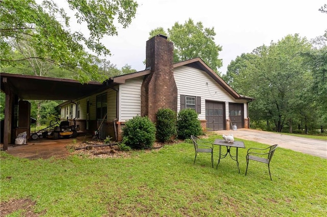 265 Forest Lake Dr, Covington, GA 30016 - view of side of home featuring a chimney, a yard, concrete driveway, brick siding, and a garage