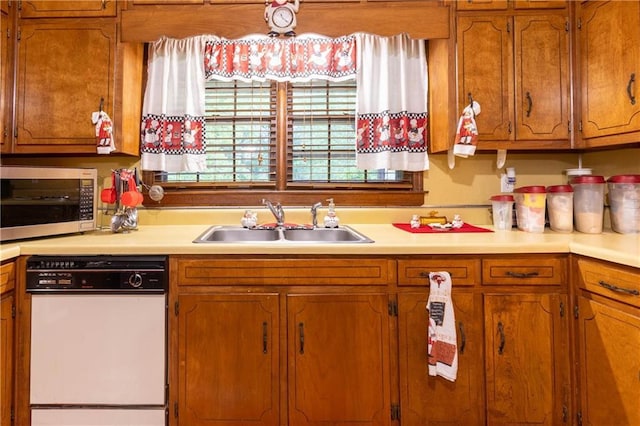 265 Forest Lake Dr, Covington, GA 30016 - kitchen with white dishwasher, stainless steel microwave, light countertops, and brown cabinets