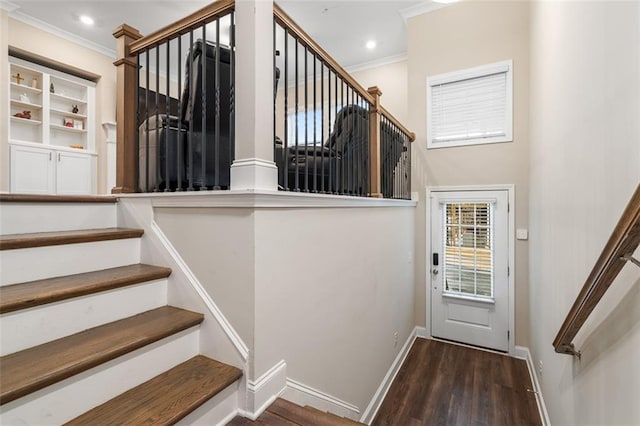 stairs with hardwood / wood-style floors and crown molding