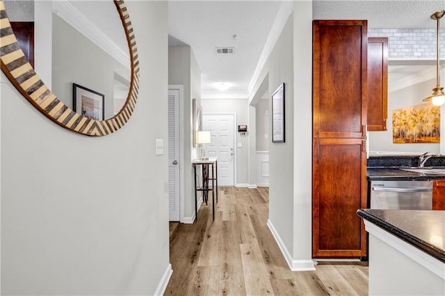 corridor featuring light hardwood / wood-style flooring and ornamental molding