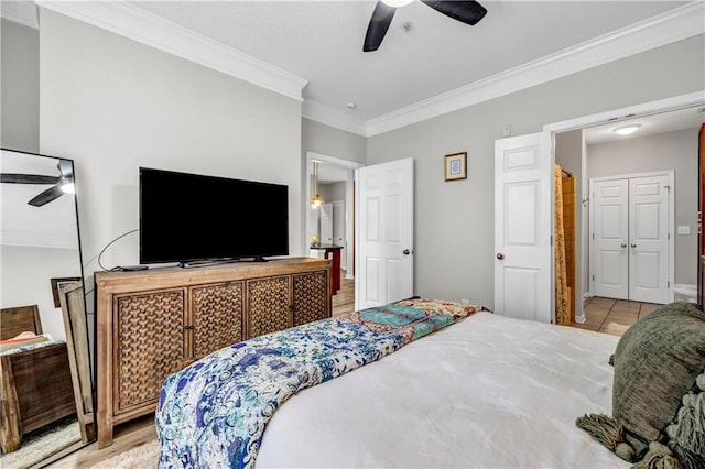 tiled bedroom with ornamental molding and ceiling fan