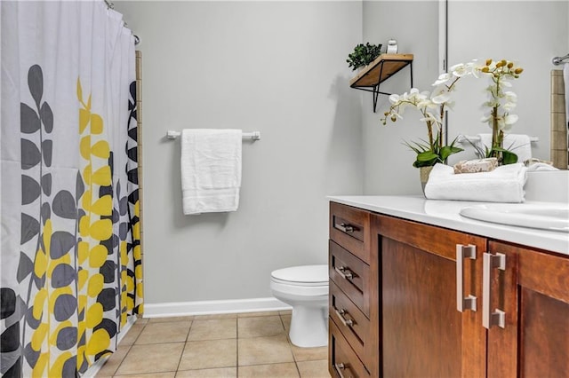 bathroom with vanity, curtained shower, tile patterned floors, and toilet