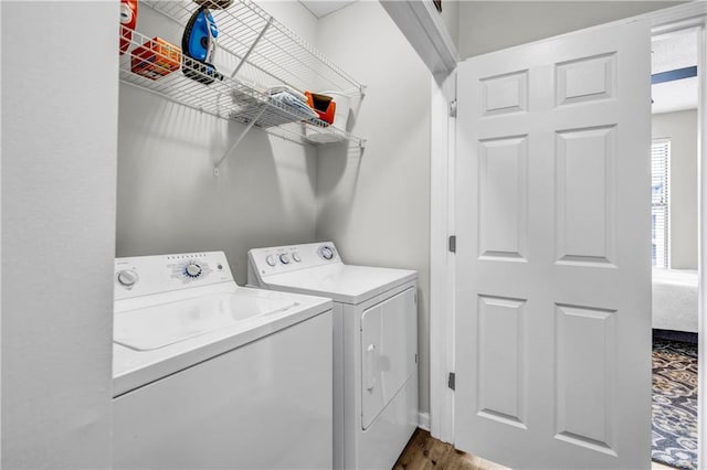 clothes washing area with wood-type flooring and washing machine and clothes dryer